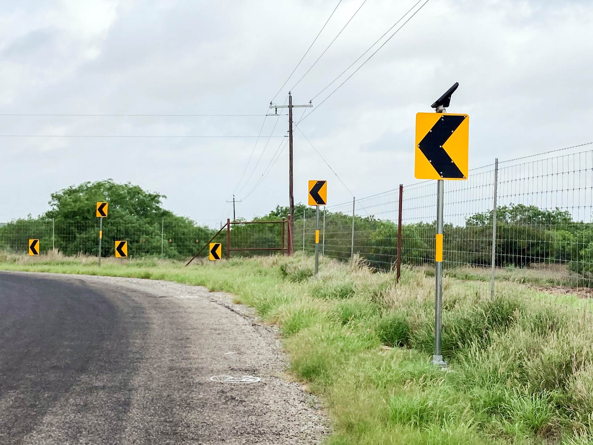 The improvements to Miles Road in McMullen County, Texas, include these solar-powered curve signs with flashing LEDs.