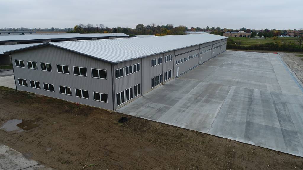 Exterior view of an airport hangar with windows at Indy South Greenwood Airport