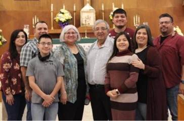 a photo of mateo's family in a church setting