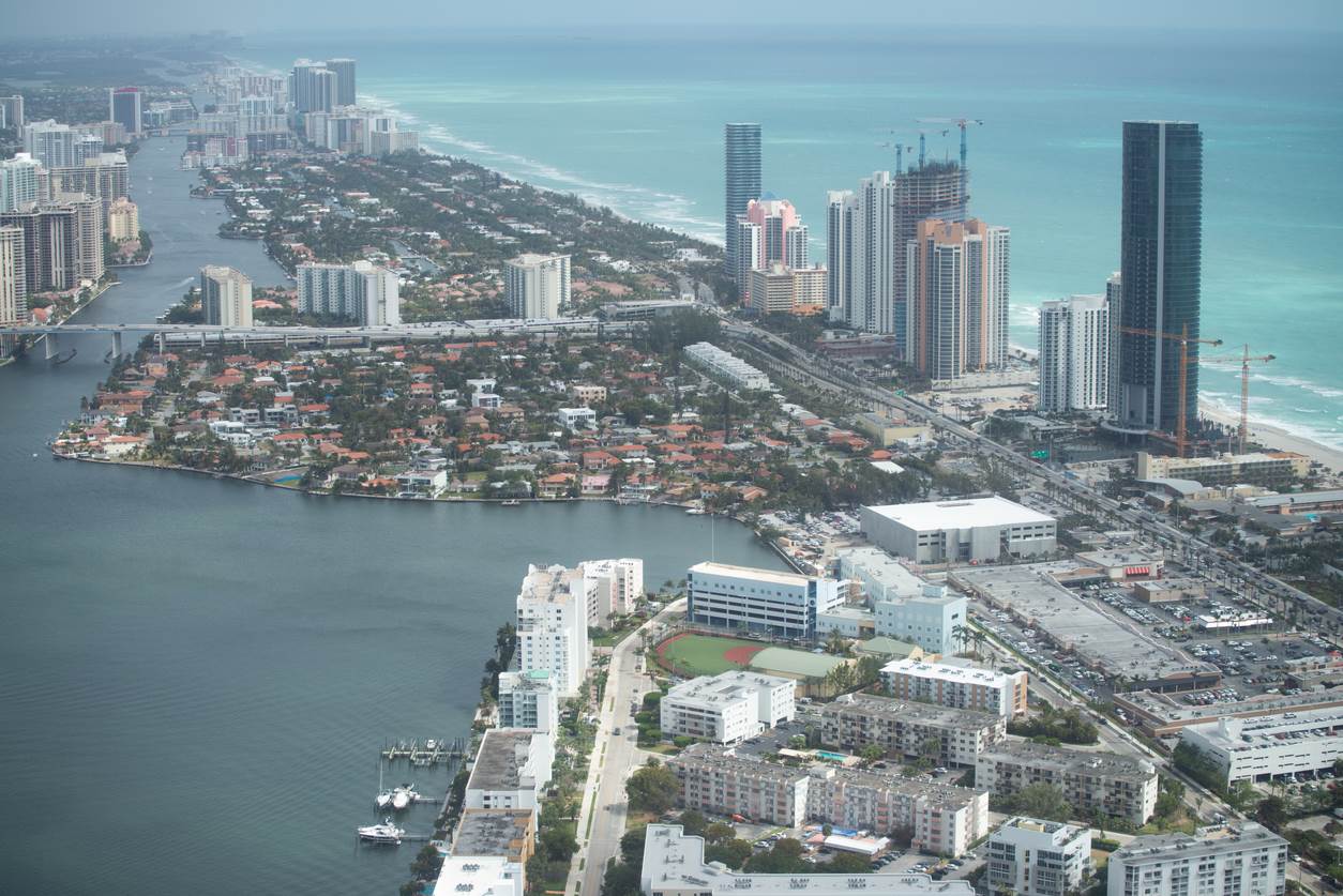 Aerial view of North Miami Beach, Florida, with building of varying heights lining the coast