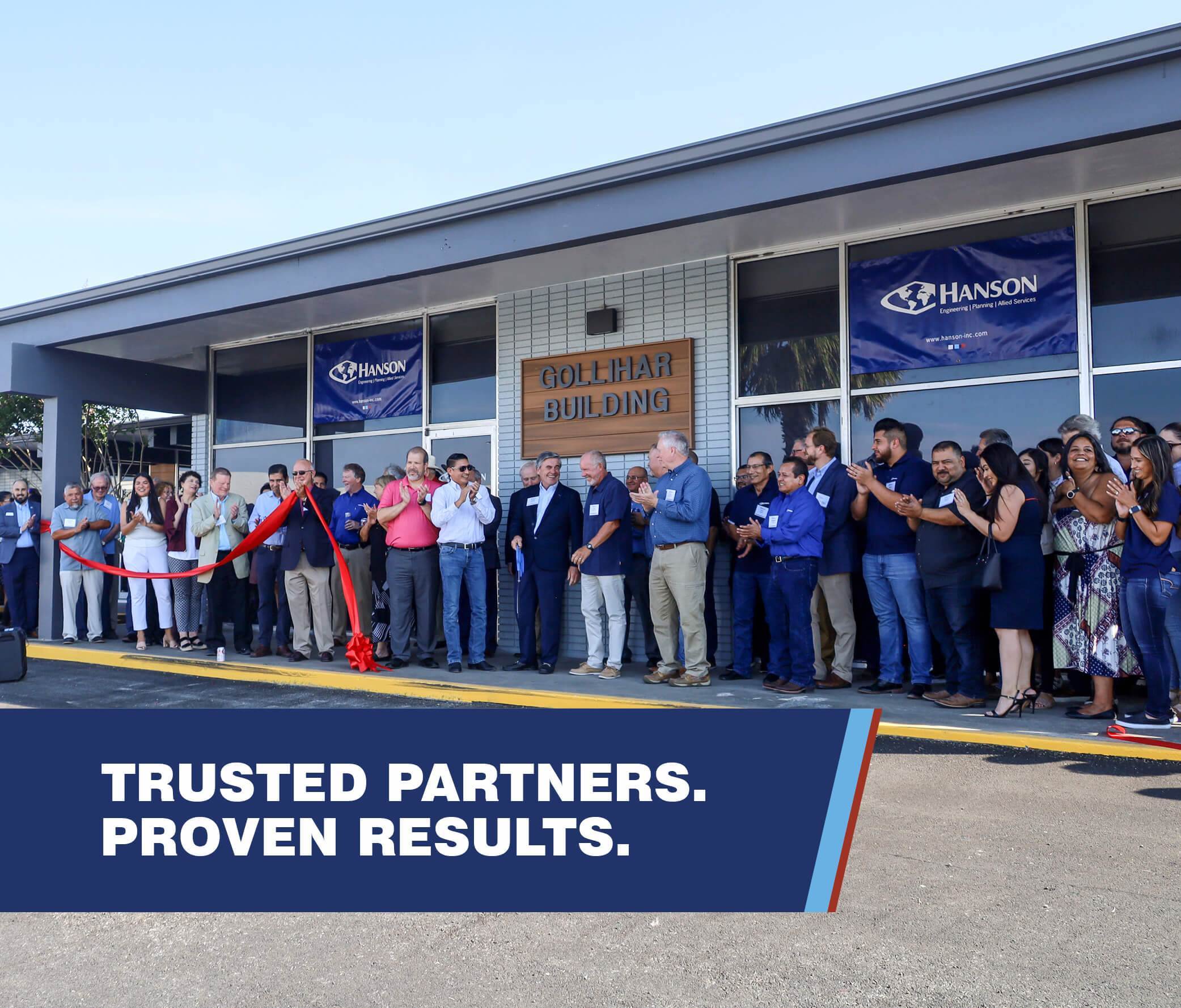 a photo of a large group of people having a ribbon cutting at Hanson's Corpus Christi, Texas office