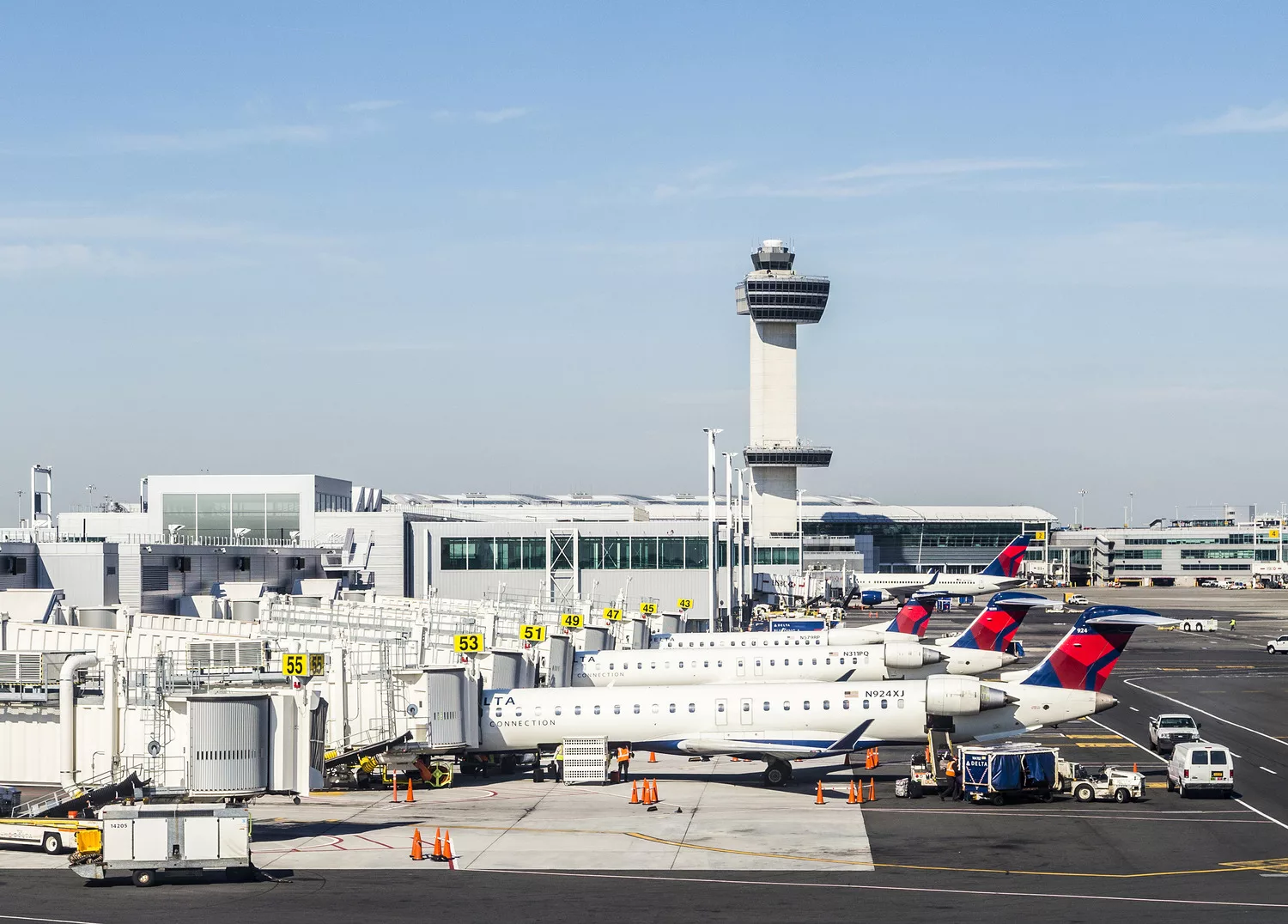View of major metropolitan airport terminal with planes in foreground