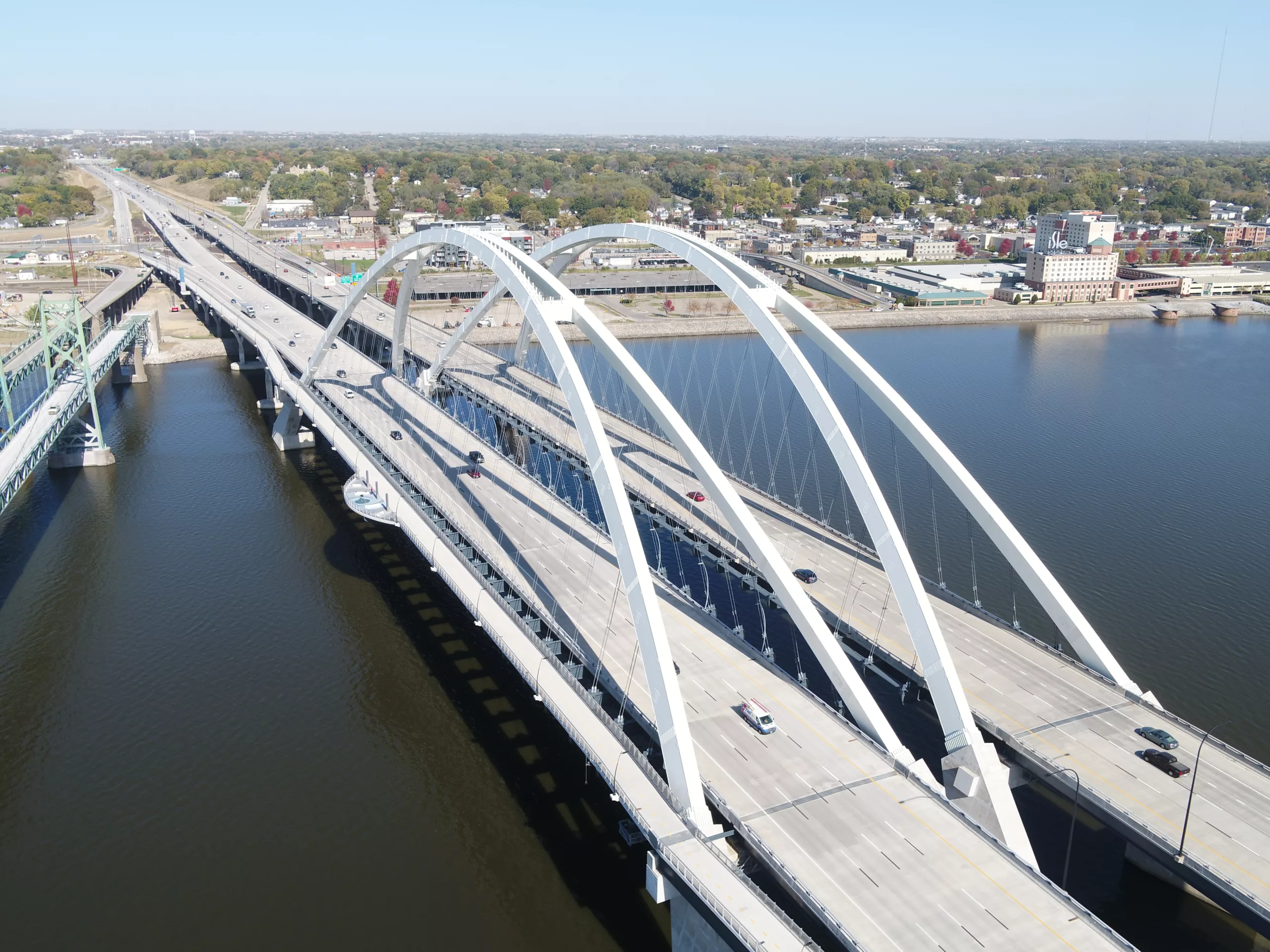 Aerial view of river bridge over water with city in background