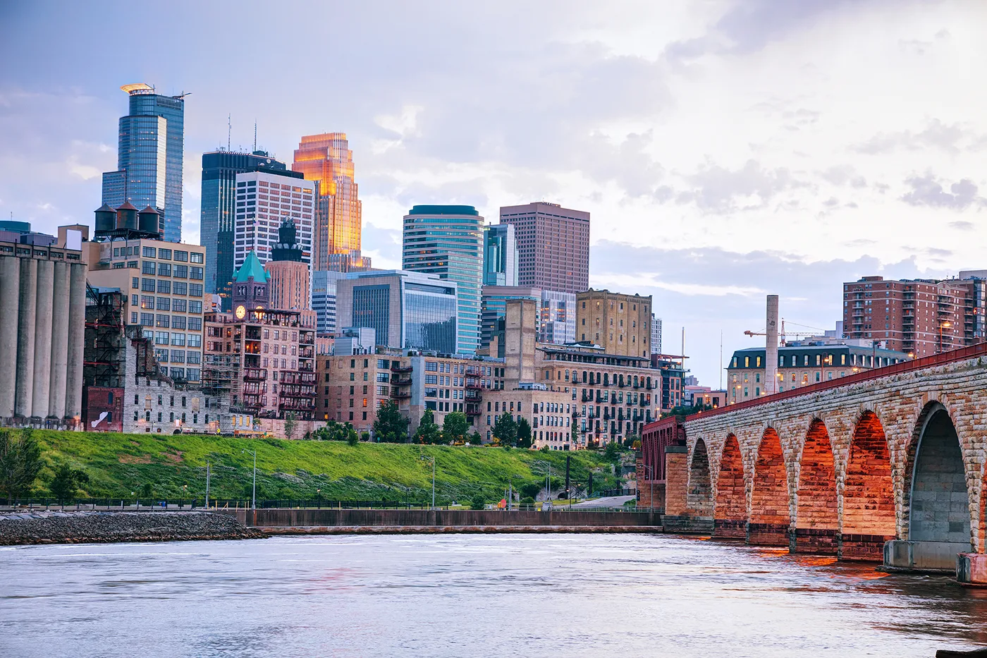 Downtown Minneapolis Minnesota at night time as seen from the famous stone arch bridge