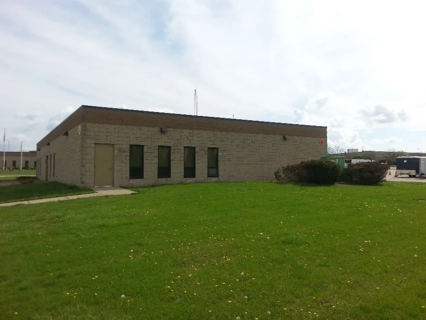 Exterior of brick military building with green grass in foreground