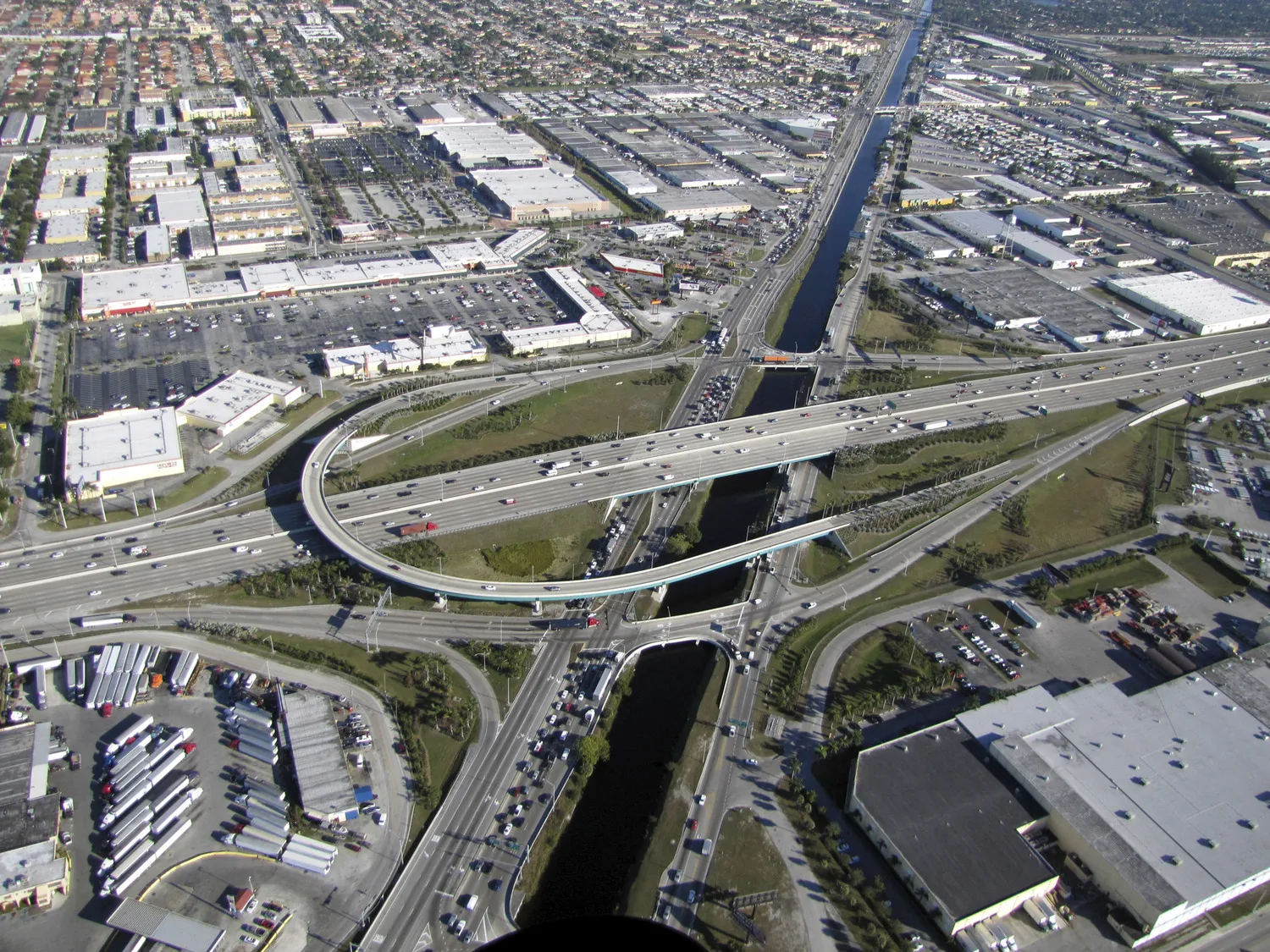 Aerial of major expressway interchange with roadway curving around