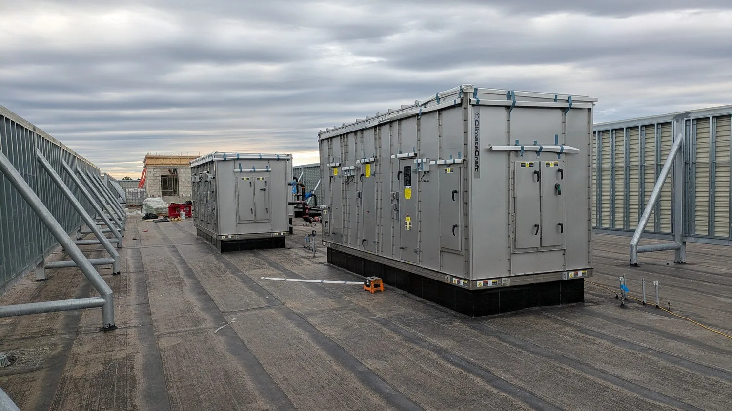 Mechanical equipment on the roof of a building with a cloudy sky above