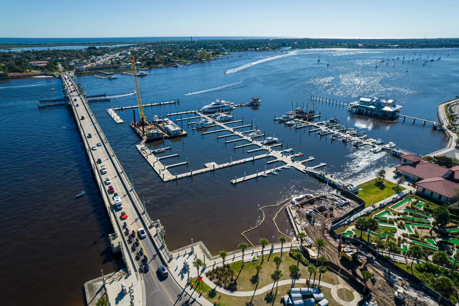 Aerial view of a boat marina with construction occurring on a drainage system
