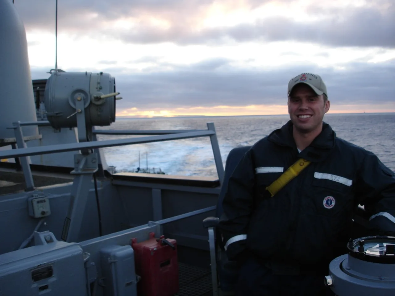 Photo of Michael Quill on the deck of a ship at sea with water in background