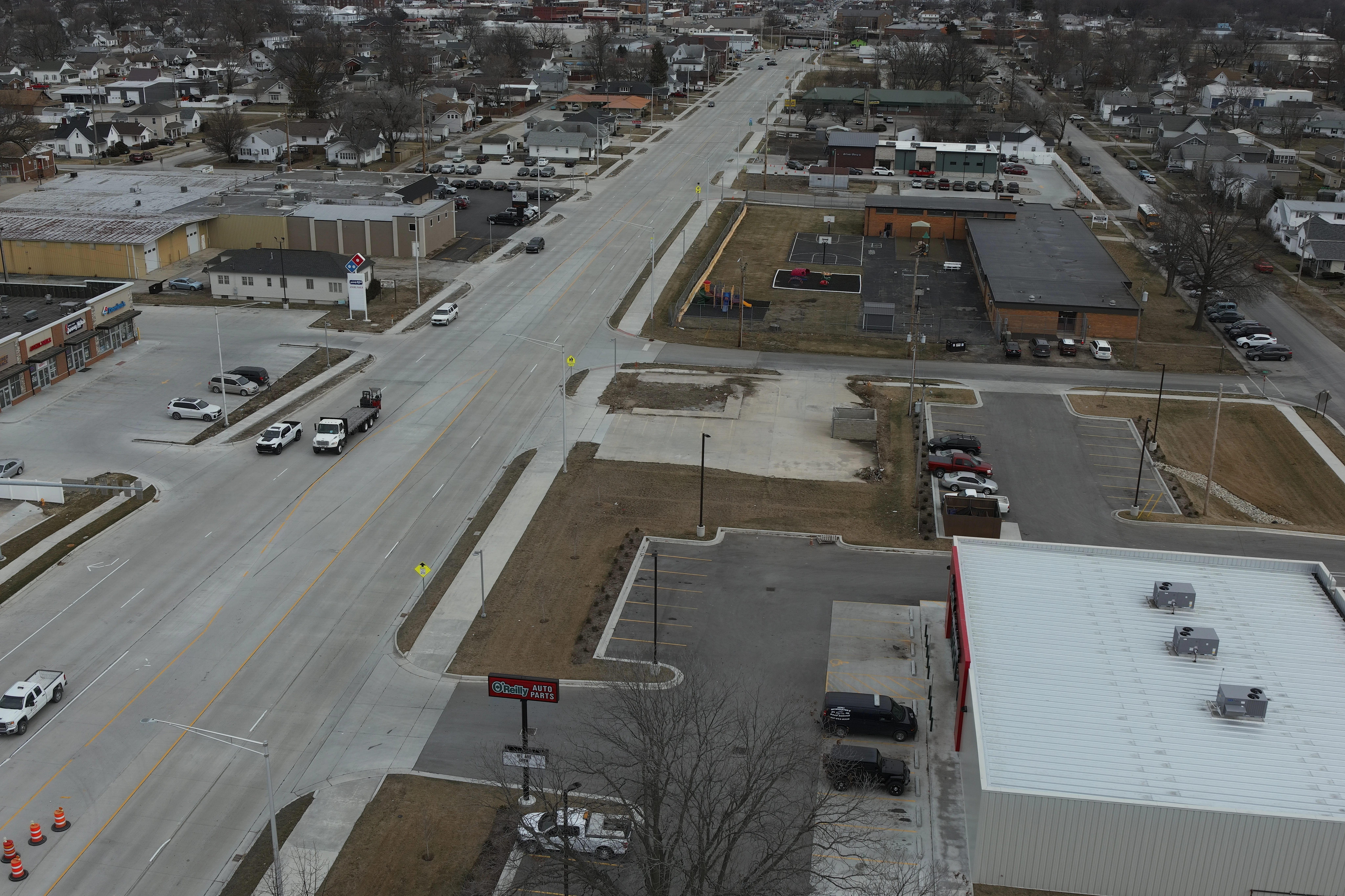 Aerial view of roadway with cars; buildings on either side
