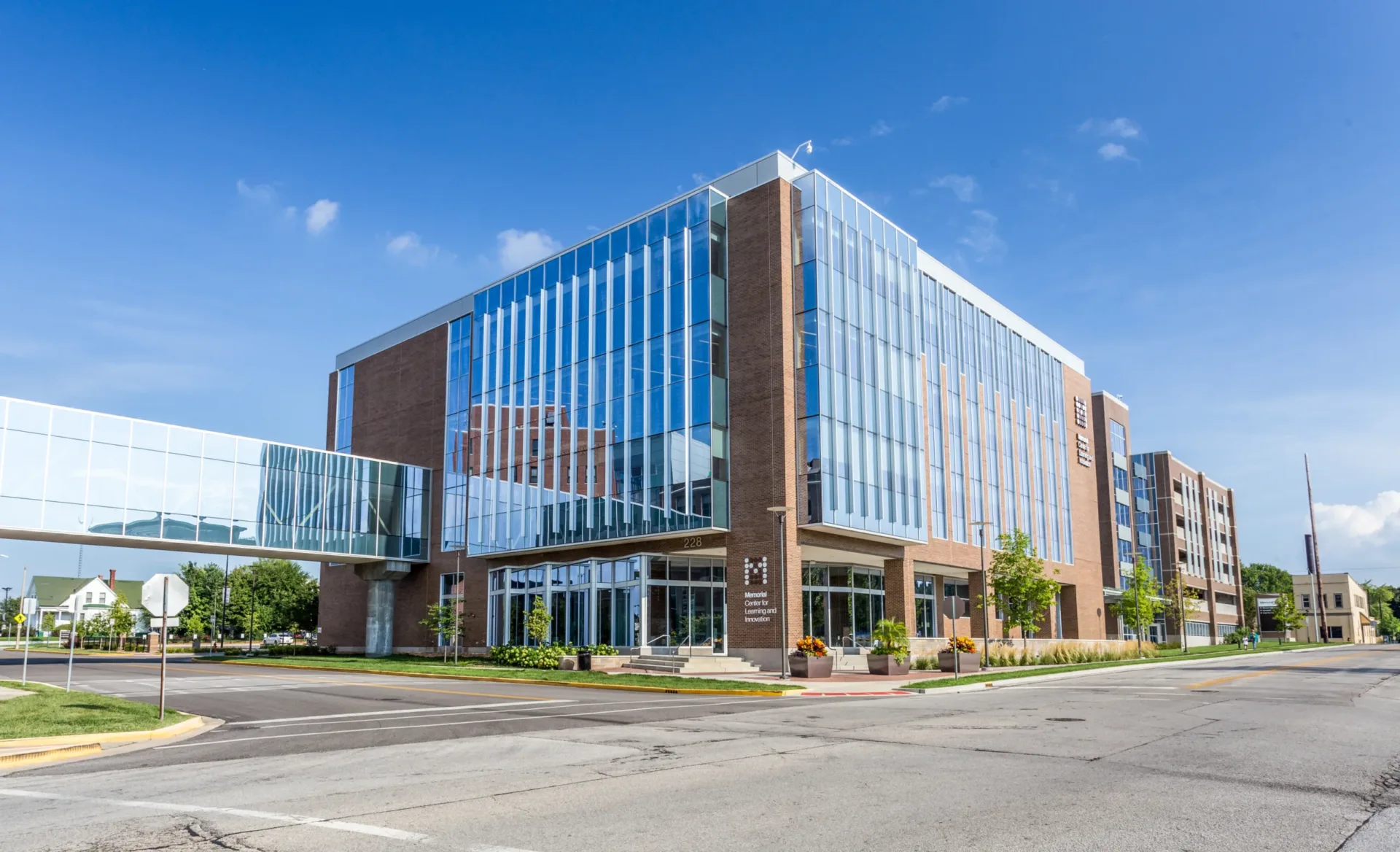 Exterior view of a medical office building with pedestrian bridge extending from left side of building