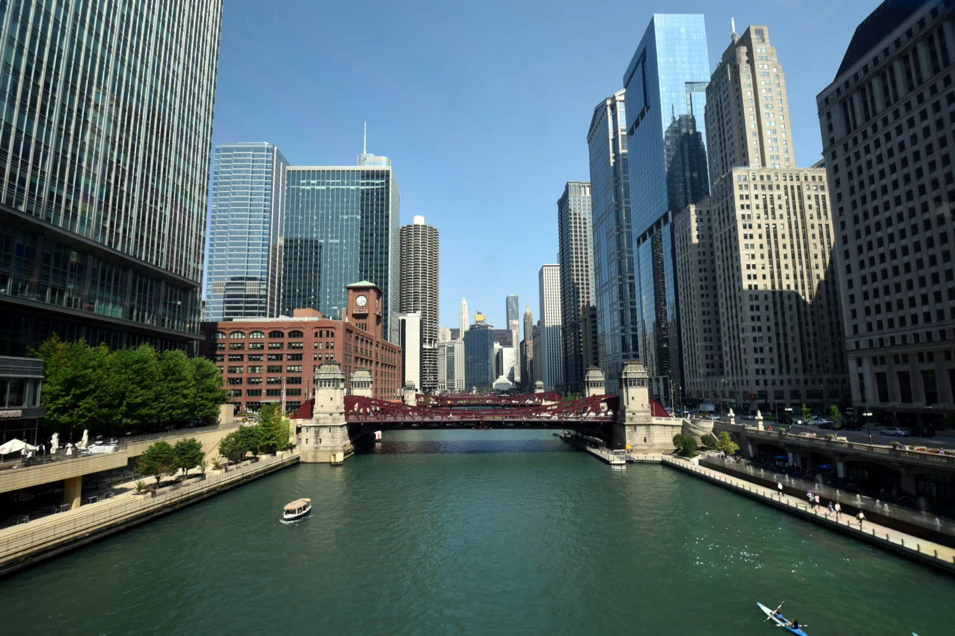 LaSalle Bridge, draw bridge over the Chicago River surrounded by high rise skyscraper office buildings under a clear blue sky in summer