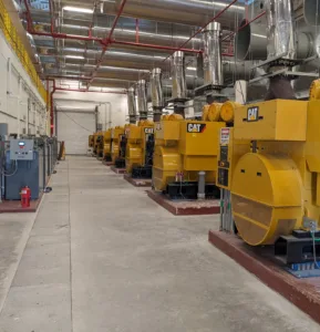 Room with concrete floor and yellow mechanical equipment on right