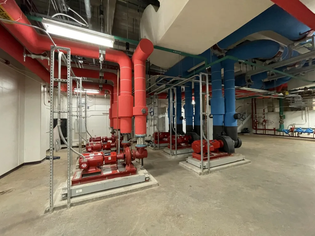 Mechanical room interior with red and blue piping