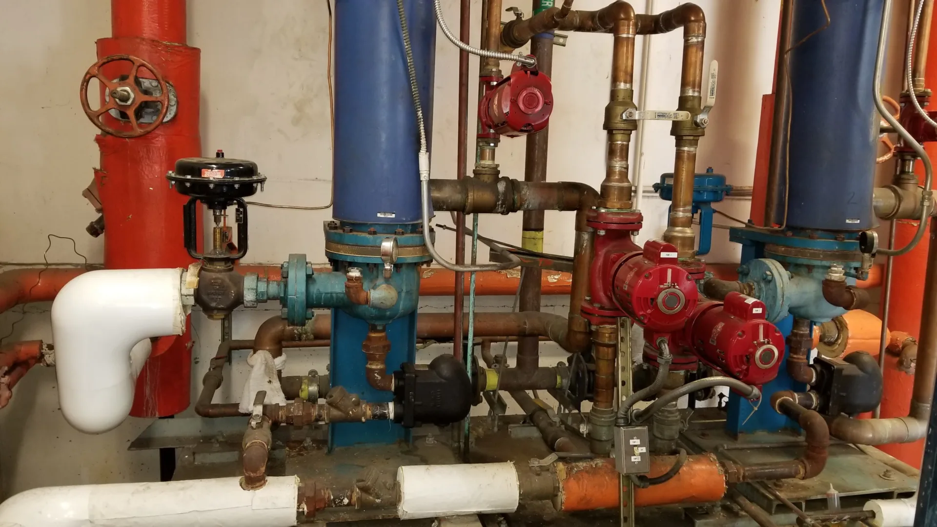 Close-up photo of colorful water pipes inside mechanical room