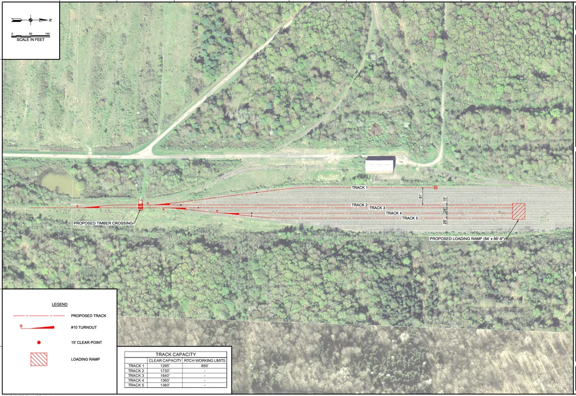 Aerial map of a railyard surrounded by trees and several roadways; tracks numbered 1 through 5. Includes legend and chart for track capacity.